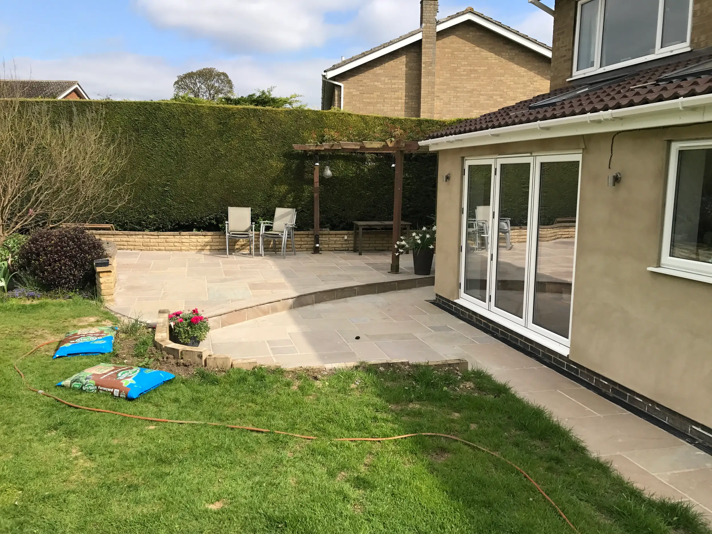 Patio and pergola taking shape in a rear garden